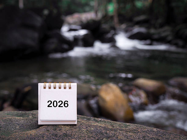 istock 2026 desk calendar on the rock with waterfall as background. Resolution, Goal, Action, Planning, and manage to success business. 2247790085