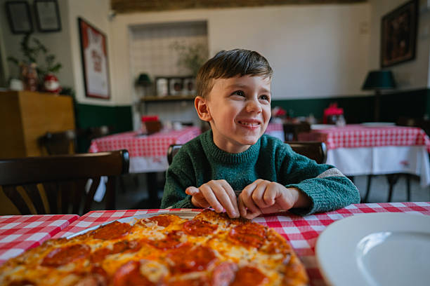 Little boy enjoying pizza
