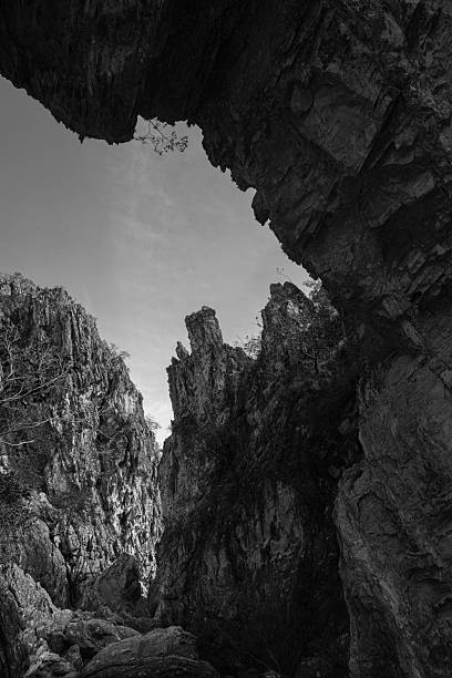 istock Natural Stone Bridge Arch Framing Rocky Landscape (Black and White) 2247790463