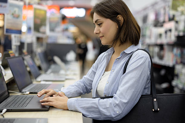 istock Gen Z Woman Testing Laptop in Electronics Store 2247791537