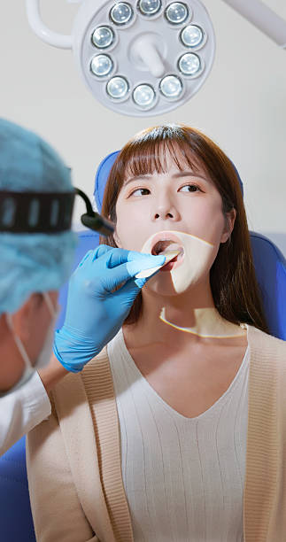istock Otolaryngologist use tongue depressor checking patient throat 2247792328