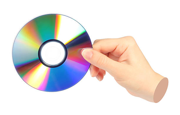 istock Hand holds cd compact disk, isolated on transparent background, retro teachnology concept. Contemporary art design 2247792581
