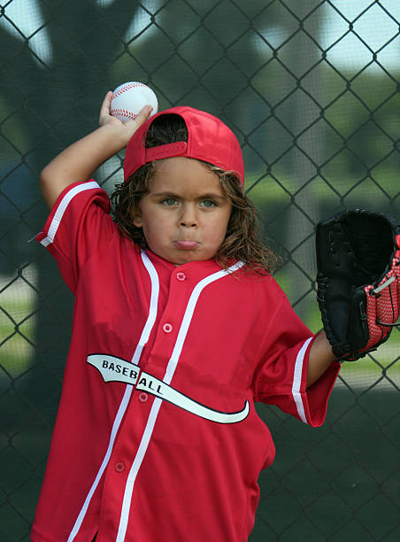 A Young boy play baseball on summer day