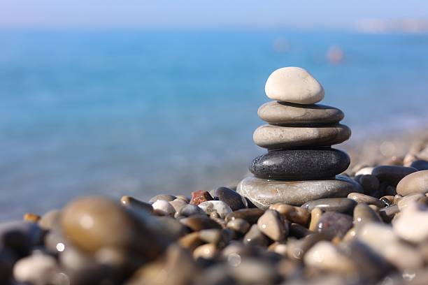 istock Stack of wet stones near sea on beach, closeup. Space for text 2247796878