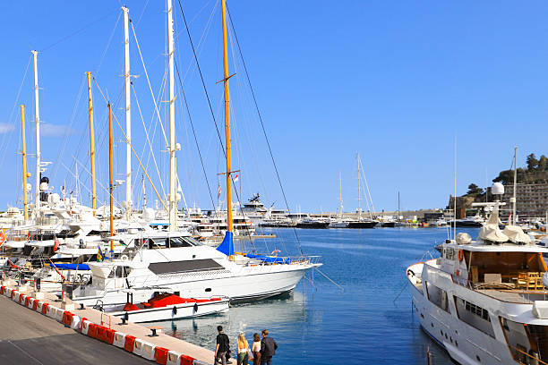 Monte Carlo, Monaco - January 18, 2012: Aerial View of Motor Boats Sailboats and Yachts Moored at Hercules Harbour Floating Pier Sunny Winter Day.