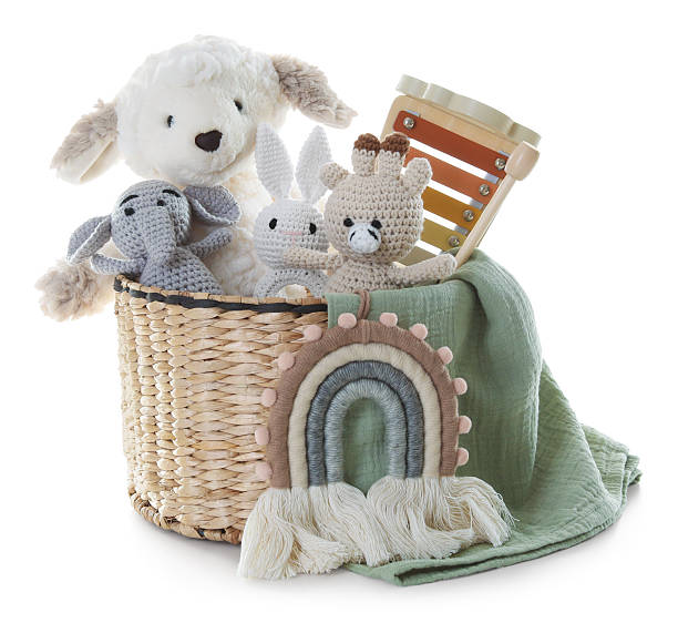 Different toys in wicker basket isolated on white