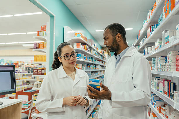 istock Two pharmacists talking about a medicine in the pharmacy. 2247798856