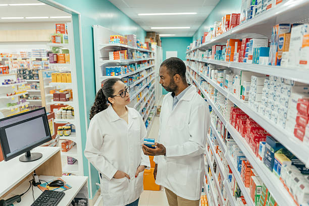 istock Two pharmacists talking about a medicine in the pharmacy. 2247798860