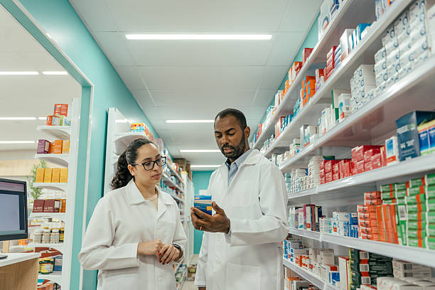 istock Two pharmacists talking about a medicine in the pharmacy. 2247798861