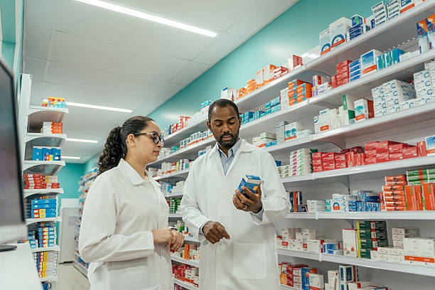 istock Two pharmacists talking about a medicine in the pharmacy. 2247798882