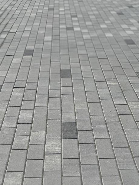 istock installing paving stones for a new driveway 2247799215