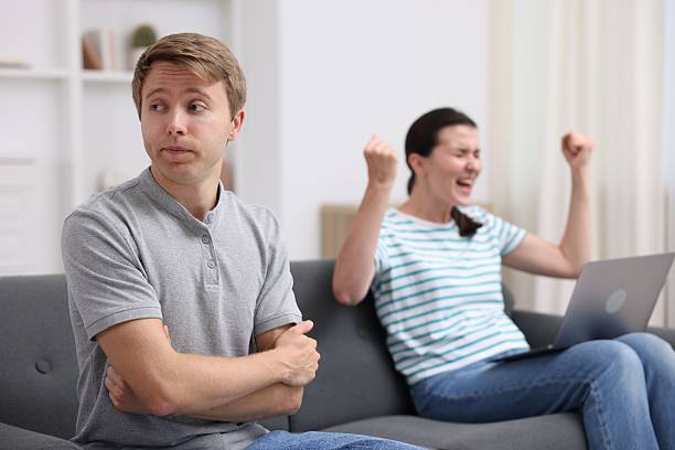 istock Man feeling jealous of woman's success at home, selective focus 2247799902
