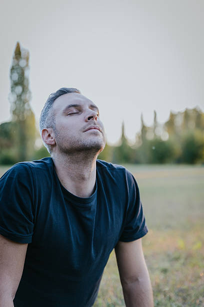 istock Portrait of a man practicing deep breathing and meditation outdoors in autumn park 2247802755