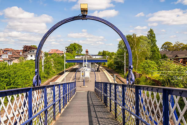 A footpath leading from street level down to the platforms of Muirend station in Glasgow's southside, photoographed in late spring.