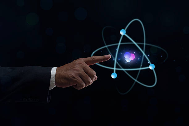 istock Businessman hand holding creative atom on blue background. Nuclear fusion concept, endless energy, cheap electricity, future technologies. Science and future concept 2247806660