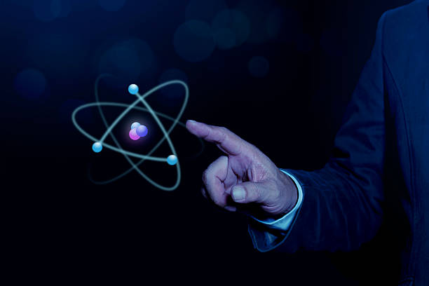 istock Businessman hand holding creative atom on blue background. Nuclear fusion concept, endless energy, cheap electricity, future technologies. Science and future concept 2247806811