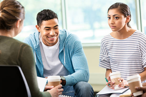 istock Diverse group of young adults engaged in conversation while holding coffee cups 2247807146