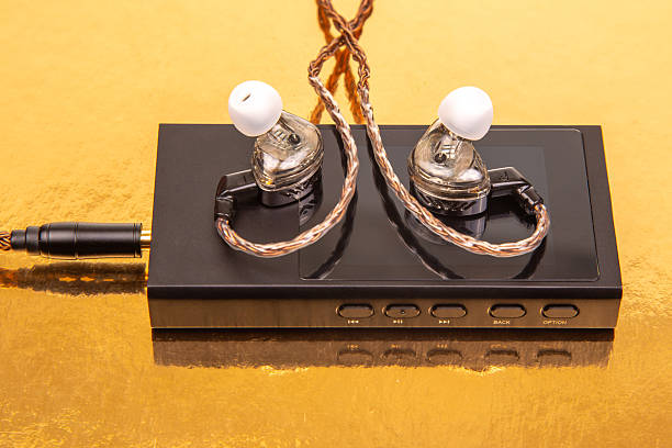 istock Quality earphones and sound device on golden surface showcasing audio technology features 2247807272