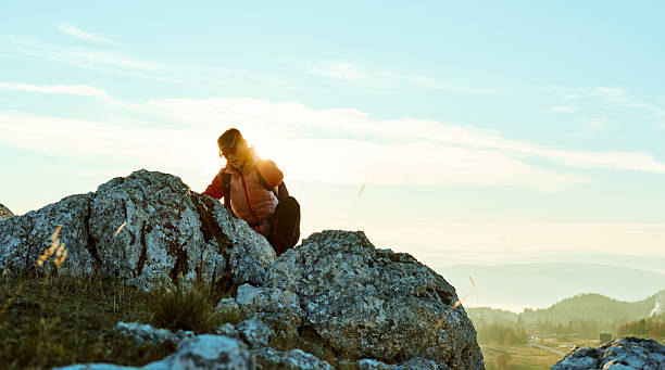 istock Hiker climbs rocky terrain at sunset in mountainous landscape under clear sky 2247808329