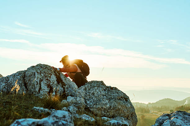 istock Hiker climbs rocky terrain at sunset in mountainous landscape under clear sky 2247811862