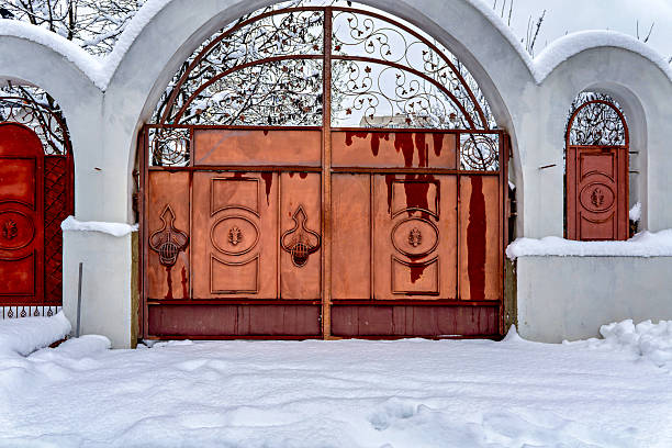 istock a snow-covered archway with three red doors each featuring a circular design and a metal grille above them 2247817394