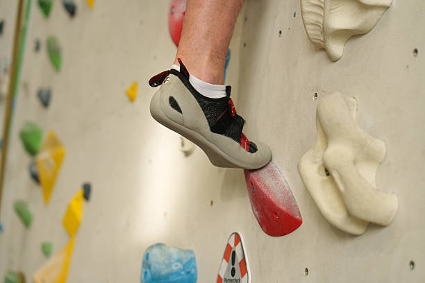istock Feet on climbing wall in indoor gym 2247819403