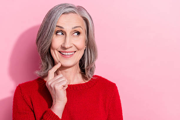 istock Portrait of attractive curious cheerful gray-haired woman creating solution copy space isolated over pink pastel color background 2247821984