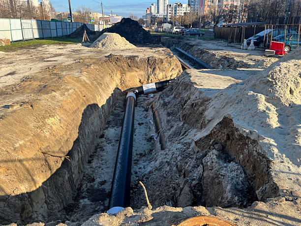 istock Urban heating pipeline construction trench in residential district 2247822533