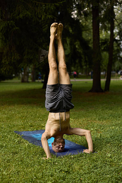 istock A dedicated Yoga Practitioner doing a Headstand Pose in a beautiful outdoor greenery 2247822711