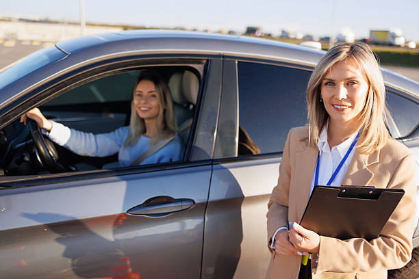 istock Driving Instructor Standing Near Car with Smiling Student Ready for Exam 2247822955