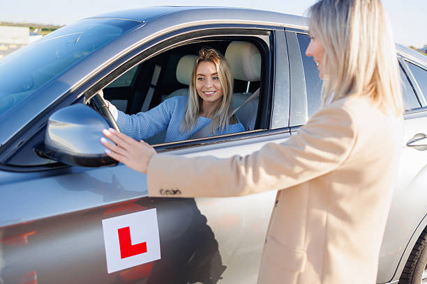 istock Driving Instructor Checking Exterior Mirrors of Learner Vehicle Before Test 2247822992