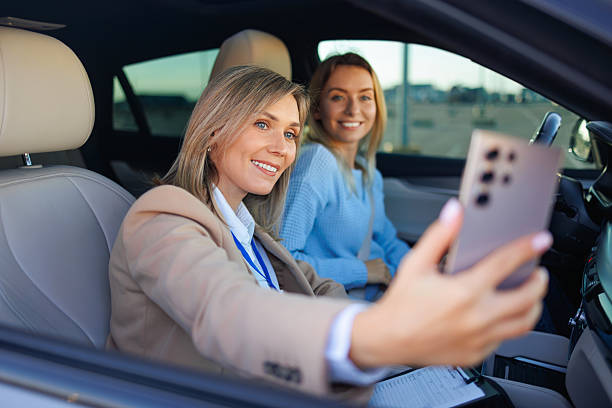 istock Driving Exam Celebration Selfie  Smiling Student and Instructor Sitting in Car 2247823269