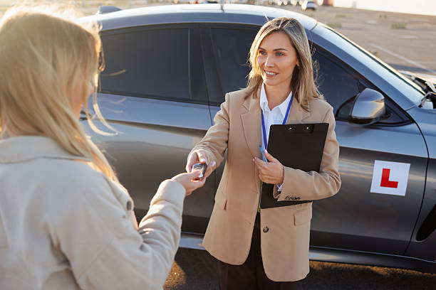 istock Driving Teacher Handing Over Car Keys to Student Before Lesson 2247823830
