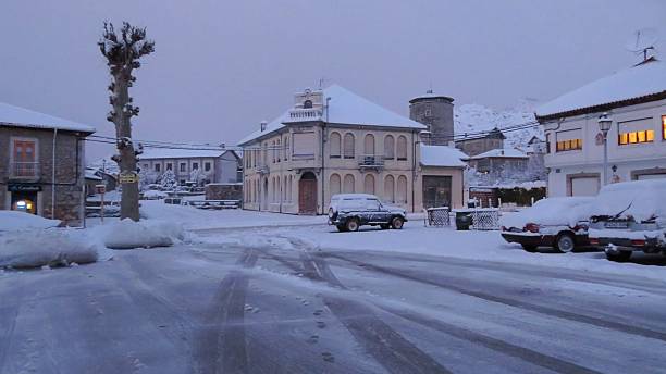 A winter cityscape from Puebla de Lillo in northern Spain, covered in heavy snow. The streets, buildings and urban infrastructure are wrapped in a white winter setting, creating a quiet and atmospheric scene. An ideal image for topics related to winter, small towns, Spanish mountainous areas, cold weather and winter tourism.