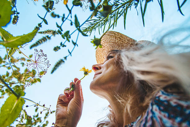 istock Woman in the park with flowers summer. Selective focus. 2247829043