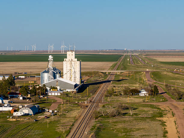 In Genoa, Colorado, a meticulously laid railroad line and its companion road stretched endlessly toward the horizon, guiding the gaze across the sweeping expanse of golden plains.