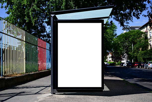 istock blank billboard, lightbox ad along sidewalk at bus stop. outdoor advertising sign panel mockup 2247832753