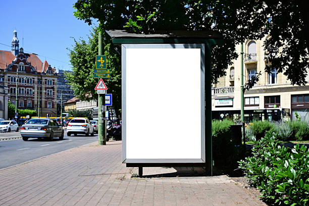 istock blank billboard, lightbox ad along sidewalk at bus stop. outdoor advertising sign panel mockup 2247832777