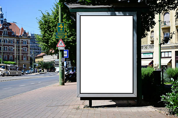 istock blank billboard, lightbox ad along sidewalk at bus stop. outdoor advertising sign panel mockup 2247832858