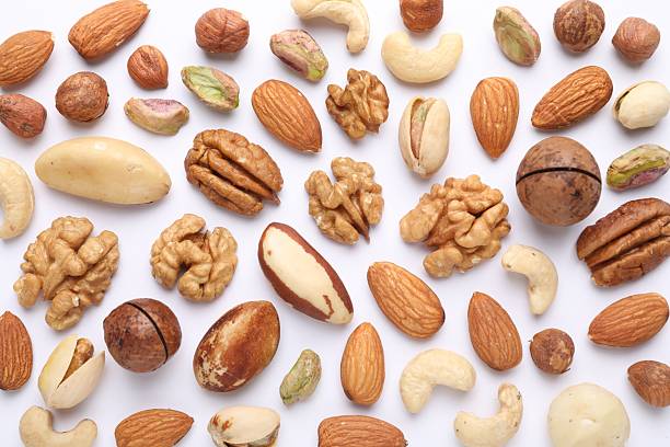 istock Mix of different nuts on white background, flat lay 2247833053
