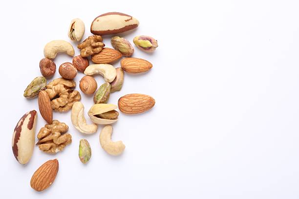 istock Mix of different nuts on white background, flat lay. Space for text 2247833110