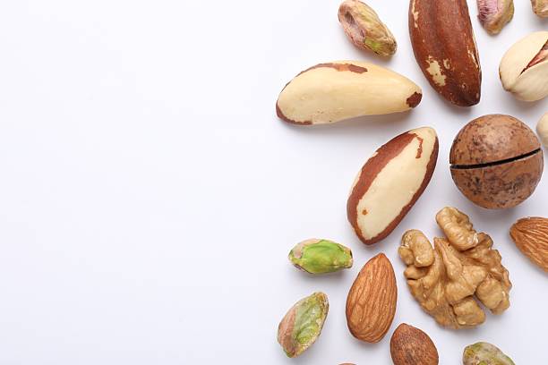 istock Mix of different nuts on white background, flat lay. Space for text 2247833116