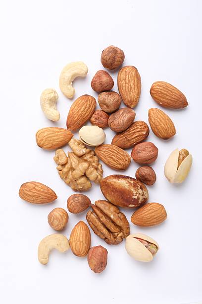 istock Mix of different nuts on white background, flat lay 2247833117