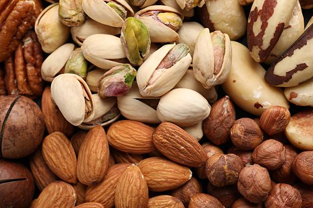 istock Mix of different nuts as background, closeup 2247833137