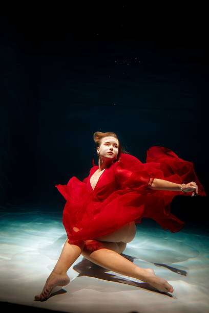 istock caucasian choreographer performing underwater in red dress 2247833149