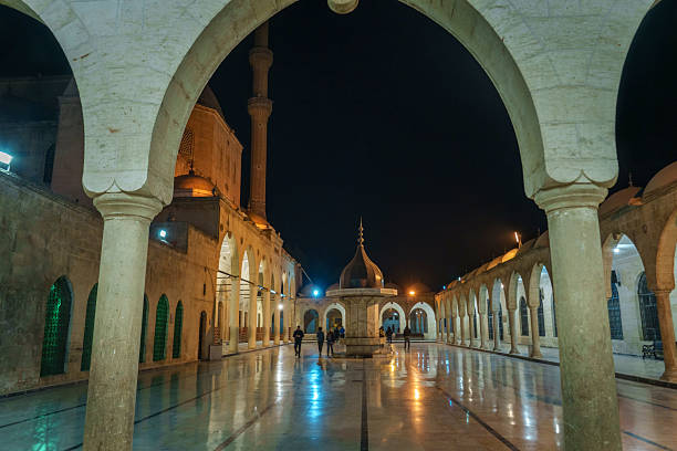 Mevlid Halil Mosque courtyard illuminating Islamic architecture and reflections at night