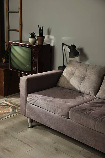 istock Soft sofa, retro TV set and other used stuff indoors 2247833288