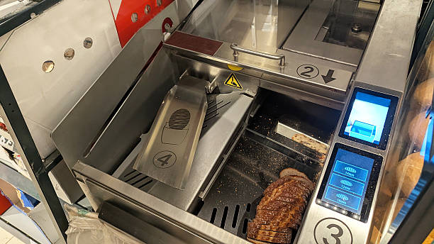 istock Automatic stainless steel bread slicing machine with digital controls in supermarket bakery 2247833869