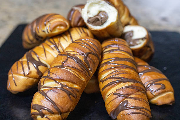 istock Chocolate-Filled Mini Rolls with Drizzled Chocolate Glaze 2247834316