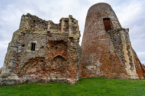 St James Church in Bawsey, near King's Lynn, Norfolk. Weathered stone ruins rise from golden grasses beneath an overcast sky, capturing a timeless, rural atmosphere perfect for history, heritage, and travel themes.